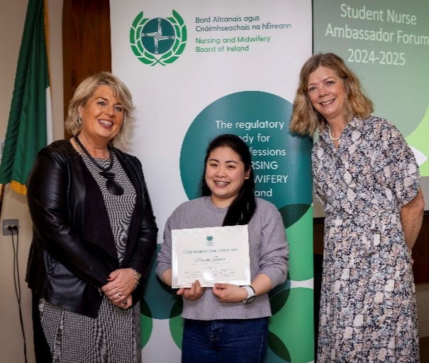 A group of women standing next to a child holding a certificateDescription automatically generated